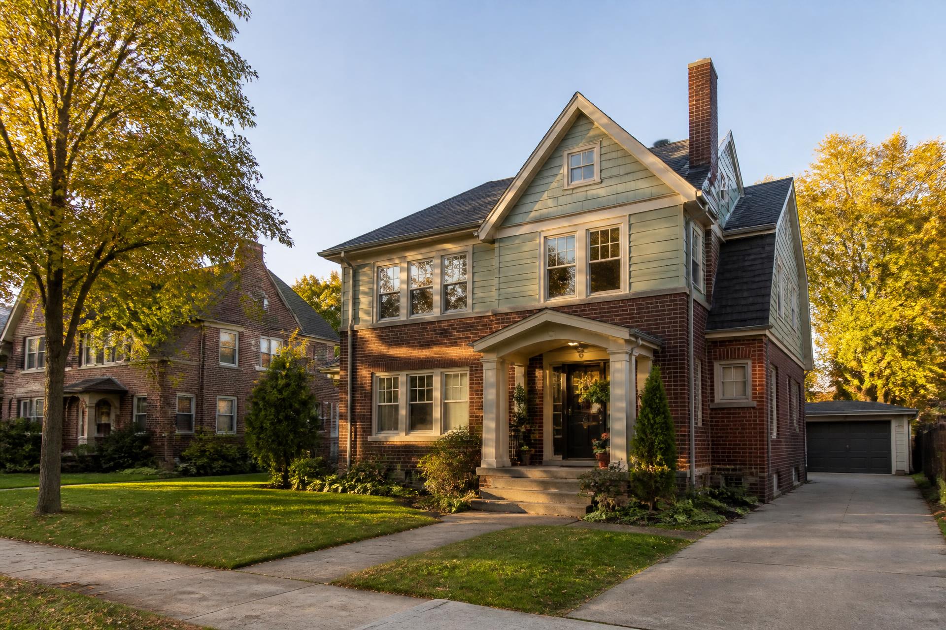 Two-story brick and clapboard home on a tree-lined Milwaukee street